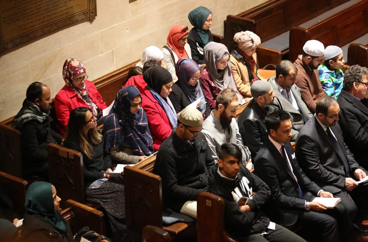 Members of the Muslim community sit together during a church service for the victims and injured from the Orlando nightclub shootings (AAP)