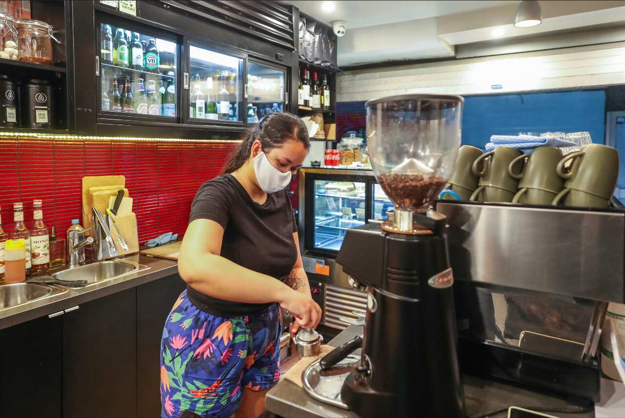 A barista prepares a coffee at a cafe in Melbourne.