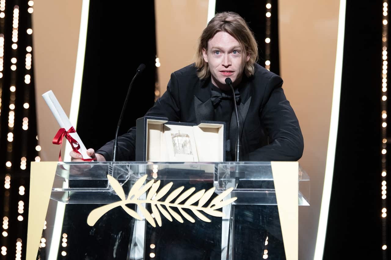 Caleb Landry Jones pictured with the Best Actor Award during the closing ceremony of the 74th annual Cannes Film Festival.