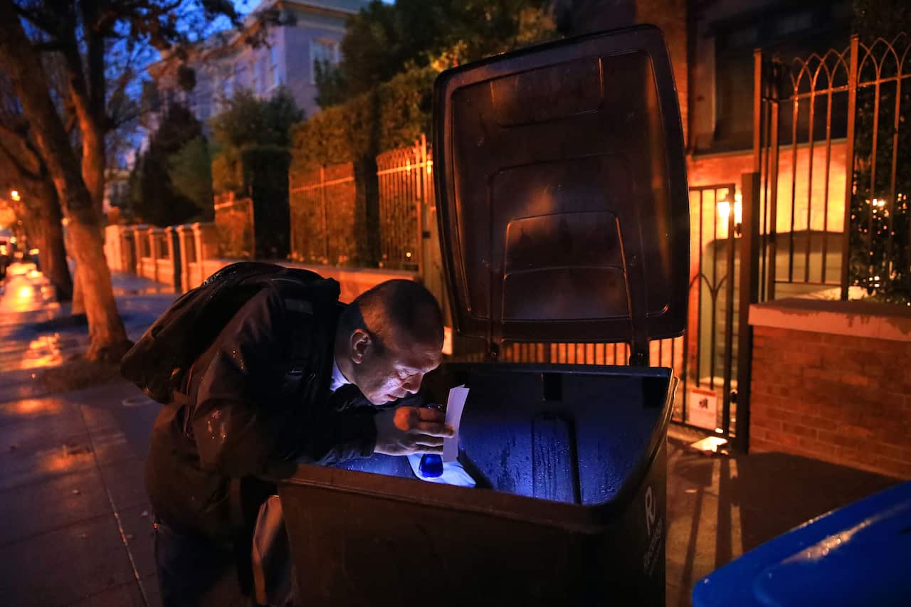 Jake Orta looks through a trash can outside of Mark Zuckerbergs home in San Francisco on April 3, 2019. 
