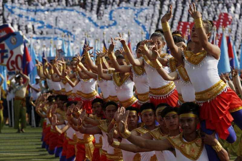  Cambodian dancers perform during a Victory Day ceremony at the Olympic National Stadium in Phnom Penh, Cambodia.
