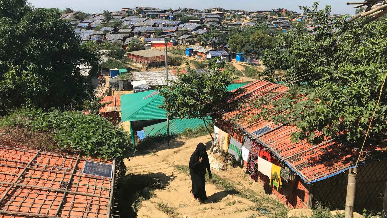 A Rohingya refugee woman walks across Jamtoli refugee camp, near Cox's Bazar, in Bangladesh.