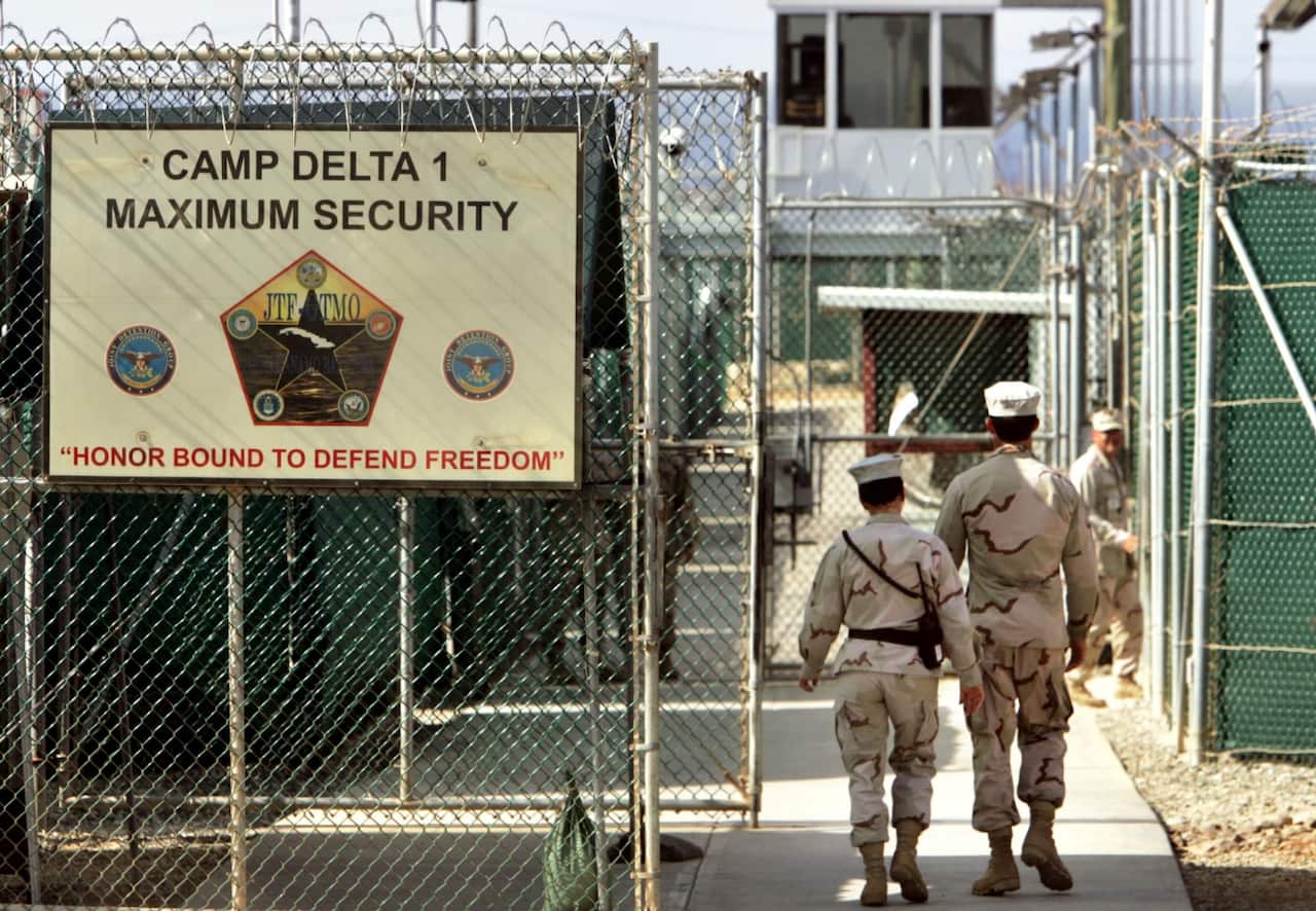 A file image of US military guards walking within the Camp Delta military-run prison, at the Guantanamo Bay US Naval Base, Cuba.