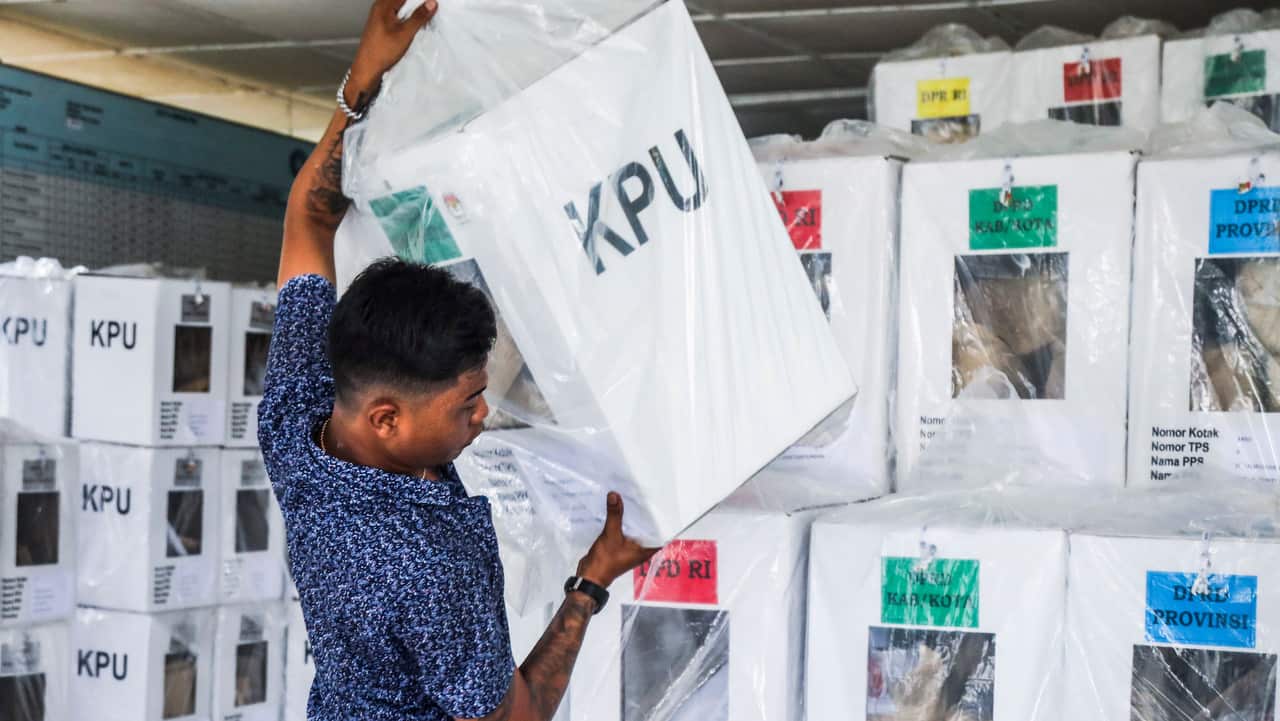 An election official carries a ballot box in Medan, North Sumatra, Indonesia.