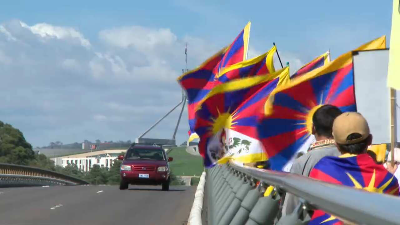 Protesters march toward Parliament House in Canberra.