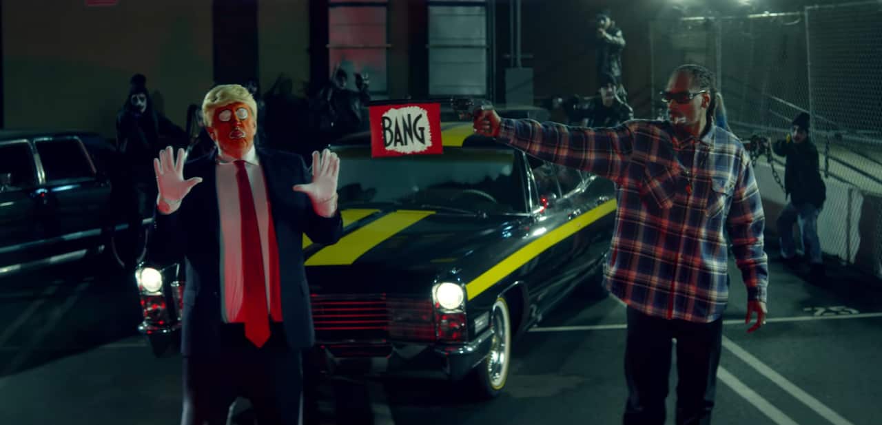 Glitter guns and 'bang' flag guns feature in the highly political video.