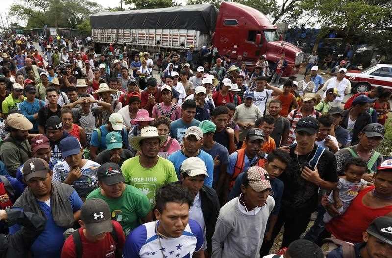 Central American migrants, part of the caravan hoping to reach the US border, wait to get a ride on a truck, in Isla, Veracruz state, Mexico.