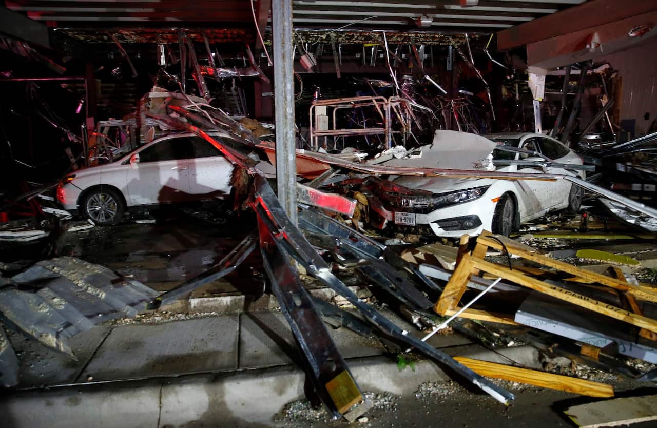 Cars and trucks are damaged as the walls blew out of the I-20 Dodge dealership after a tornado hit near Canton, Texas, Saturday, April 29, 2017. (AAP)