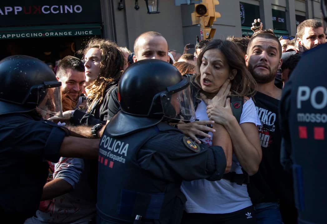 Catalan police officers clash with pro independence demonstrators.