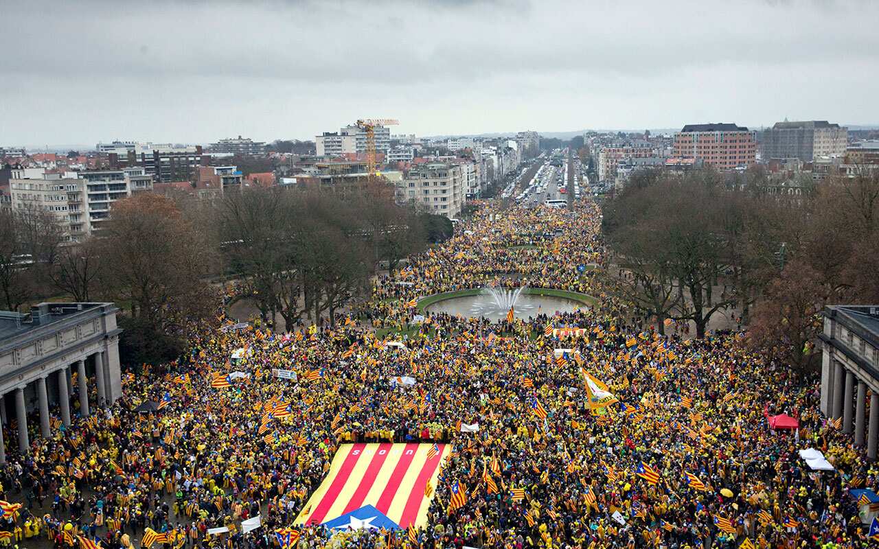 Pro-independence Catalan supporters gather to begin a demonstration near the EU quarter in Brussels on Thursday.