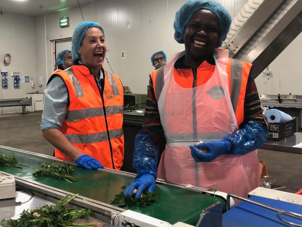 Catherine Velisha and staff member in packing room