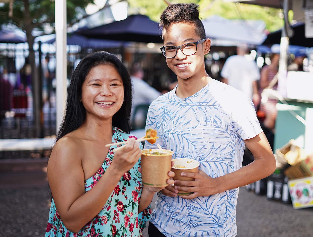 Sebastian Dela Pena and his aunt Margie Dizon enjoying Laksa at Parap markets.