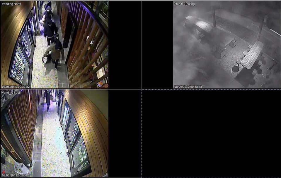 Masked protesters vandalise a 'Lennon wall' at the University of Queensland.