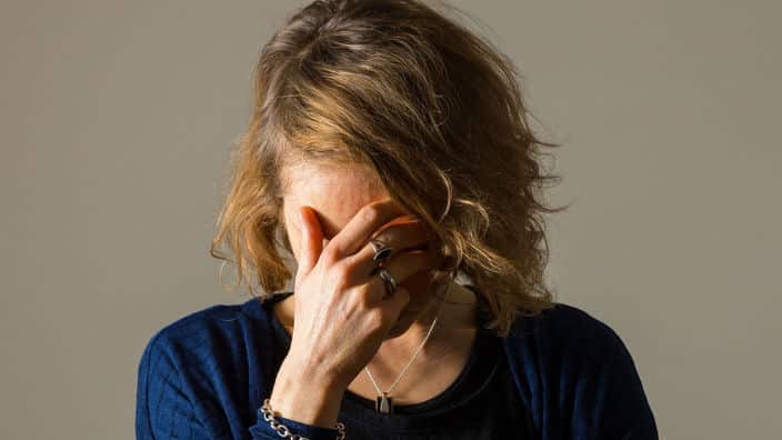 a woman with her head in her hands