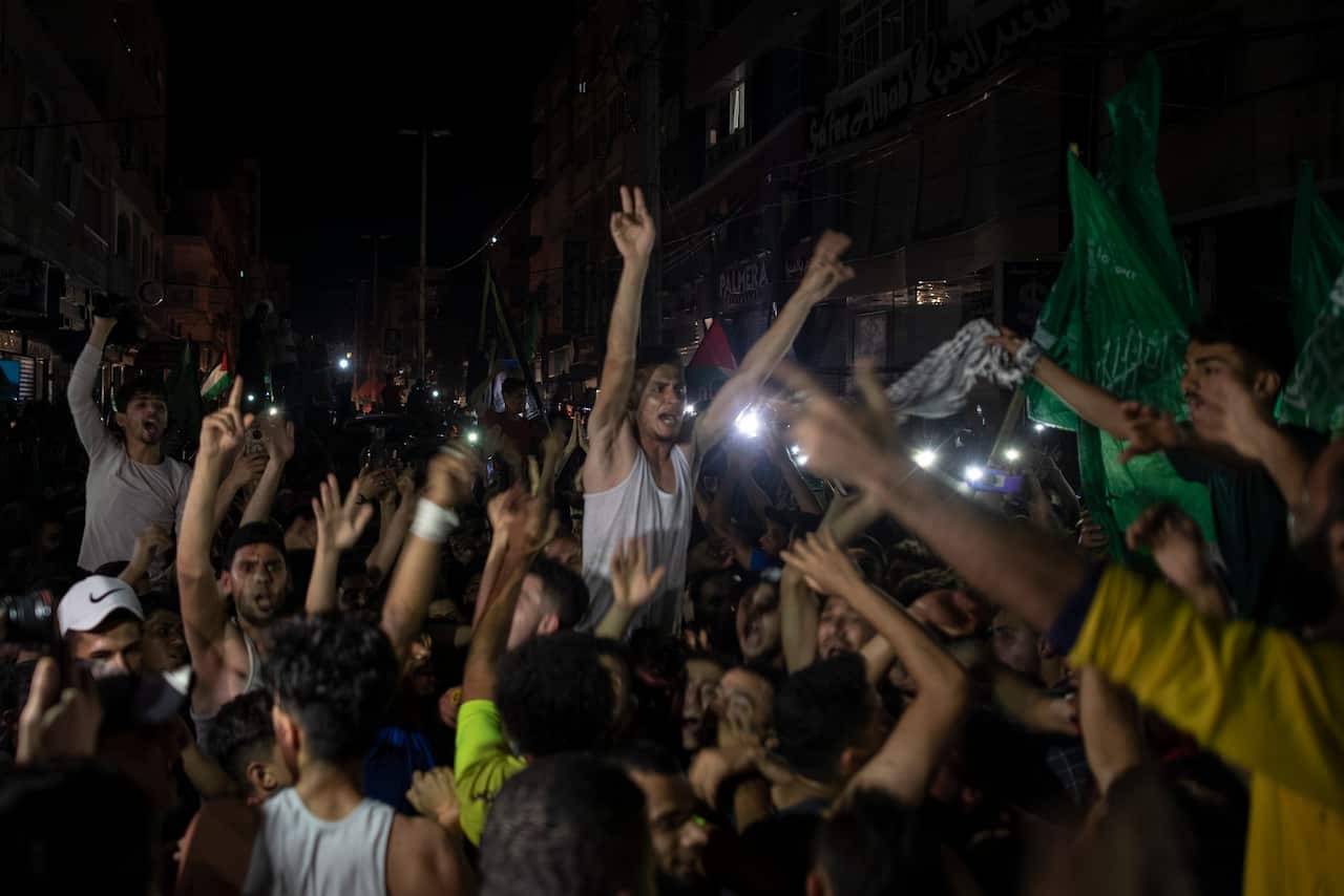 Palestinians gather in the streets of Gaza City as the ceasefire comes into effect.  