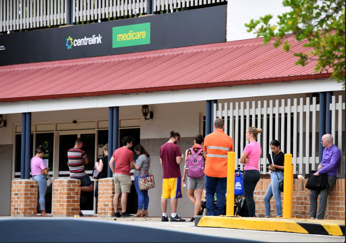 People in a long queue outside a Centrelink office in Brisbane.