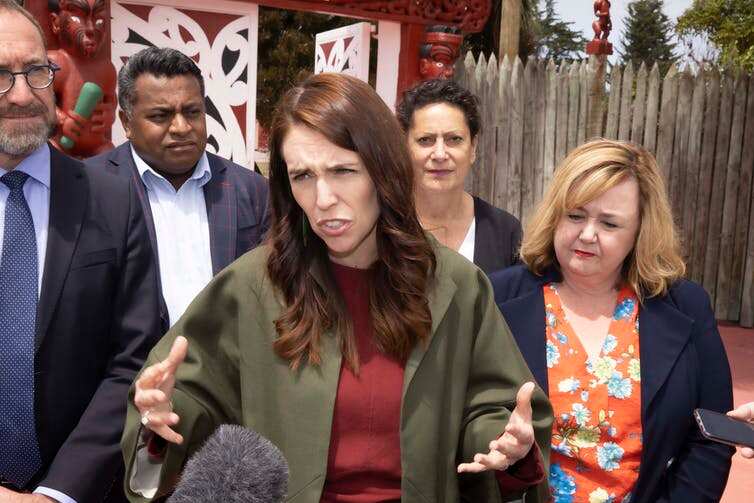 Prime Minister Jacinda Ardern and senior cabinet ministers talk to media outside Nga Hau E Wha National Marae in Christchurch, ahead of the report of the royal commission being made public.