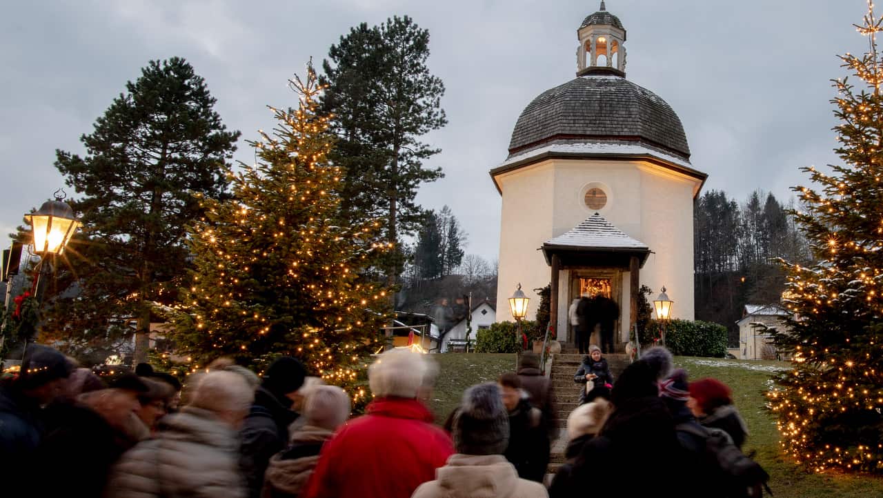 People queue up at the Silent Night Chapel on the Silent Night Square in Oberndorf, some 20 kilometers northern Salzburg, Austria.