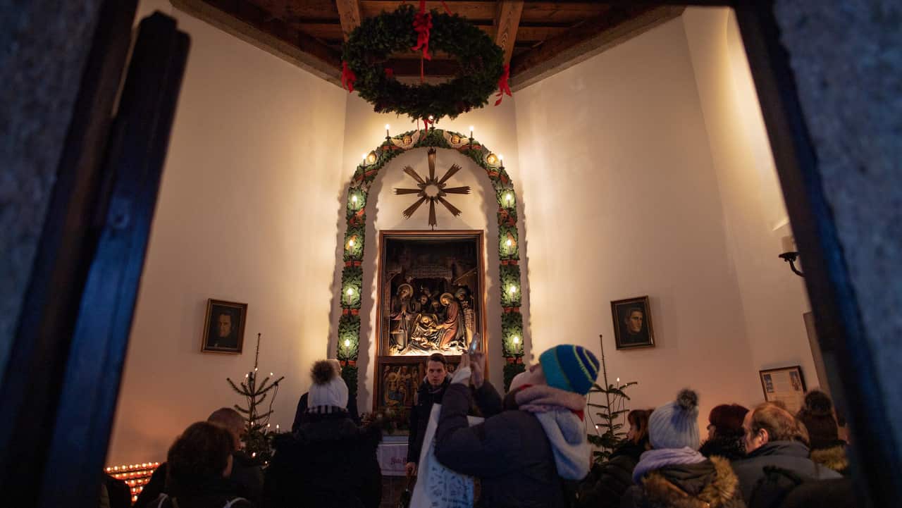 People stand inside the Silent Night Chapel on the Silent Night Square in Oberndorf.