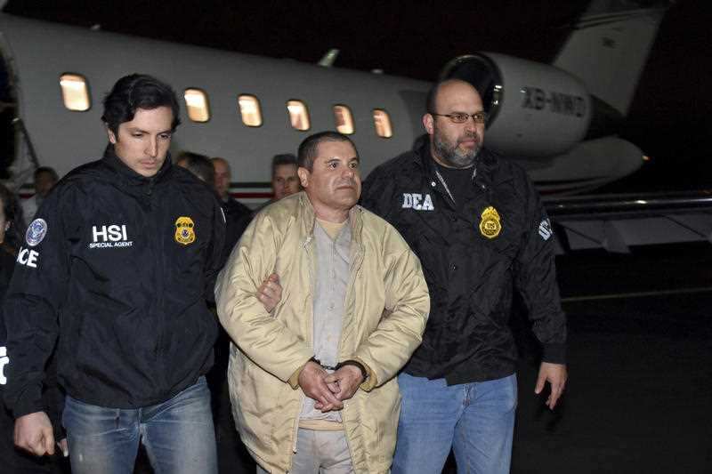 Authorities escort Joaquin "El Chapo" Guzman from a plane at Long Island MacArthur Airport.
