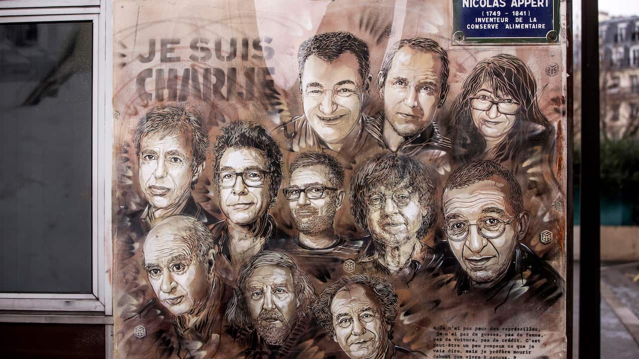 Charlie's cartoonists are depicted in a painting outside Charlie Hebdo's former office on the fifth anniversary of the attack, 7 January 2020. 