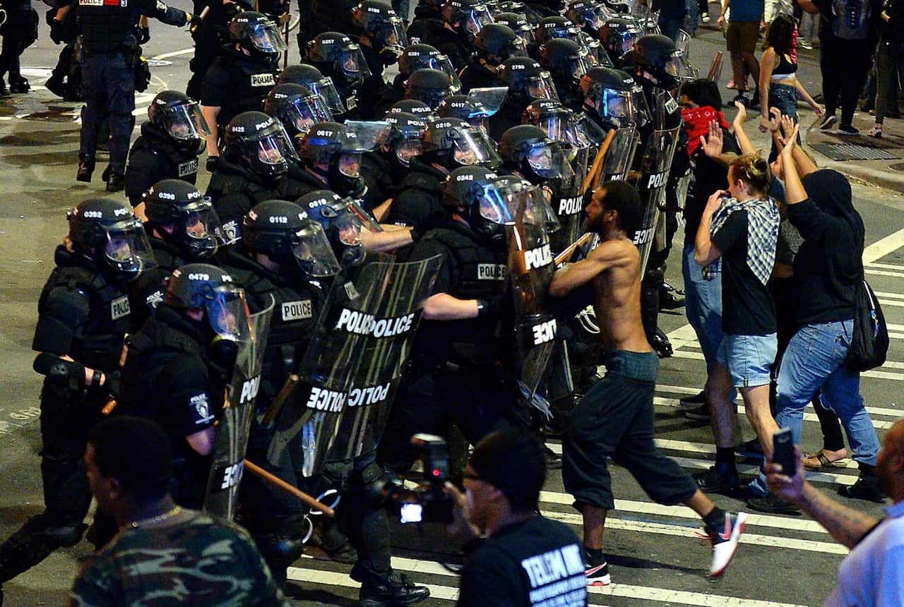 Image from Wednesday, Sept. 21, of Charlotte-Mecklenburg police officers moving protesters down a street in Charlotte, N.C.