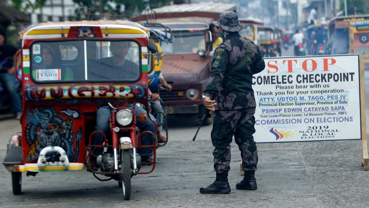 A Philippine government soldier mans a checkpoint a day after the plebiscite on the Bangsamoro Organic Law (BOL) in Jolo town.