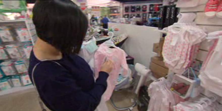 Chen shops for baby clothes.