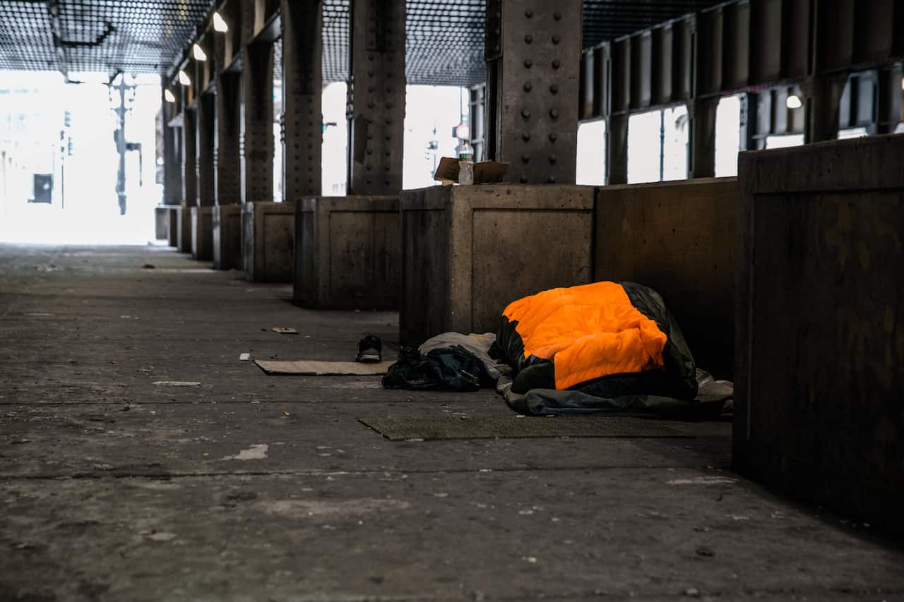 A homeless man lies under several blankets on Lower Wacker Drive in Chicago on Tuesday, Jan. 29, 2019.