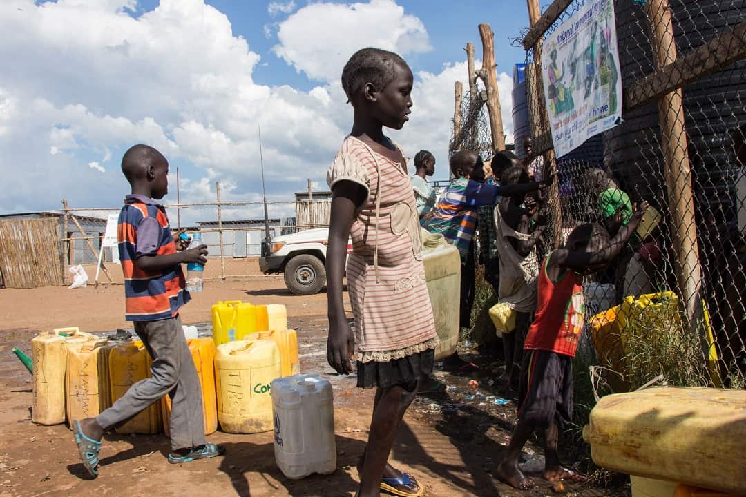 Children collect water at the Mangateen Internal Displaced persons centre in Juba, South Sudan.