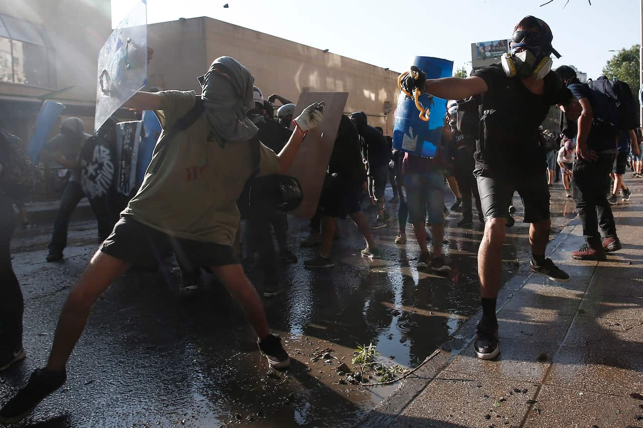 Anti-government demonstrators clash with police during protests in Santiago, Chile.