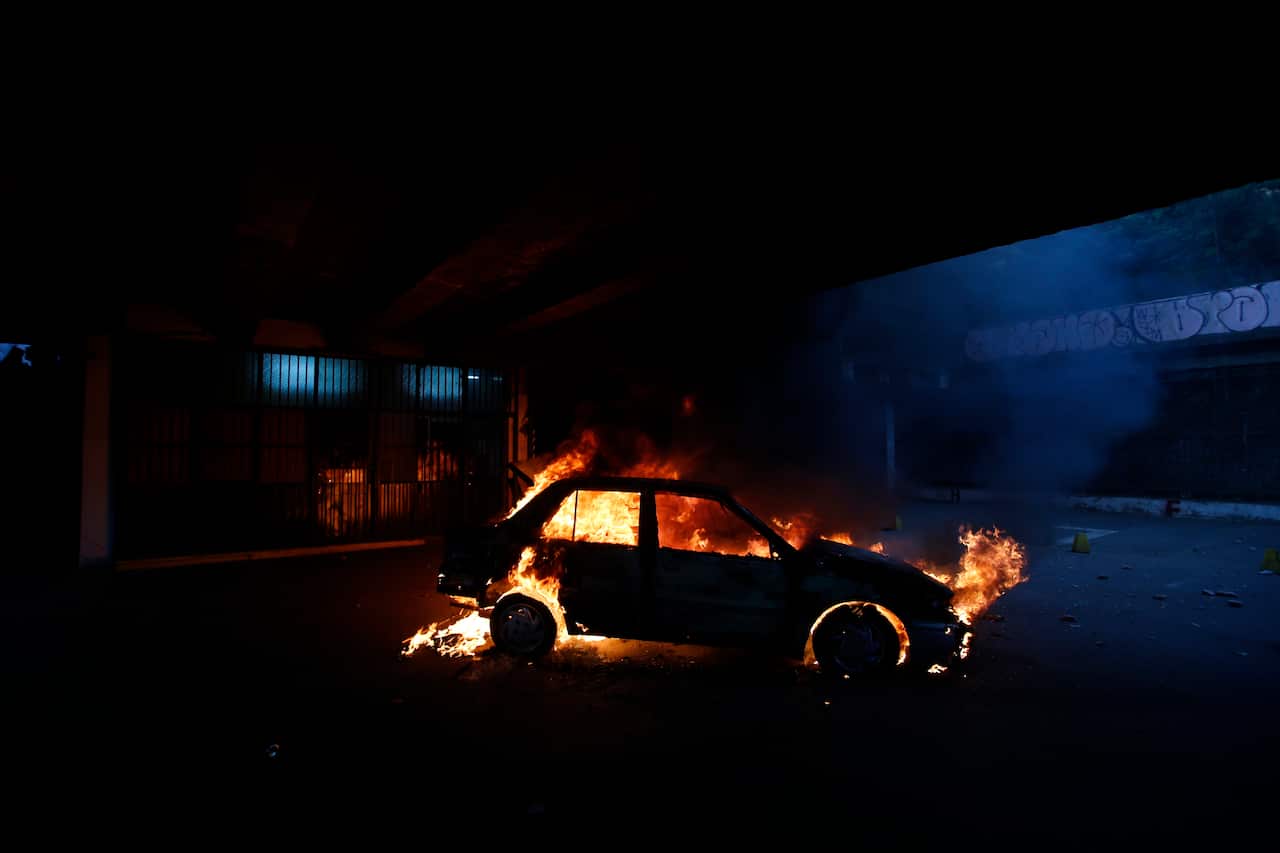 A car burns during anti-government protests in Santiago, Chile. An estimated 30 people have died as a result of wide-spread unrest. 