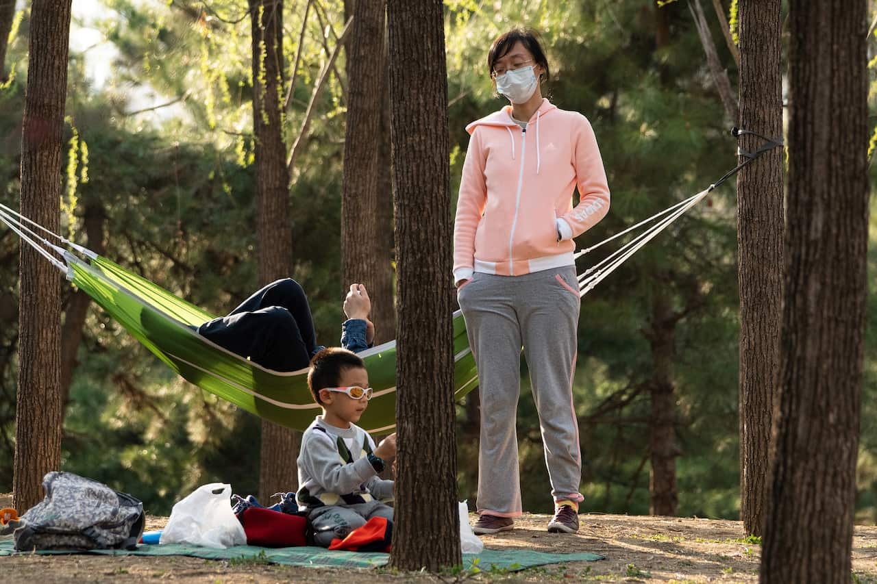 People in face masks having a picnic in Chaoyang Park.