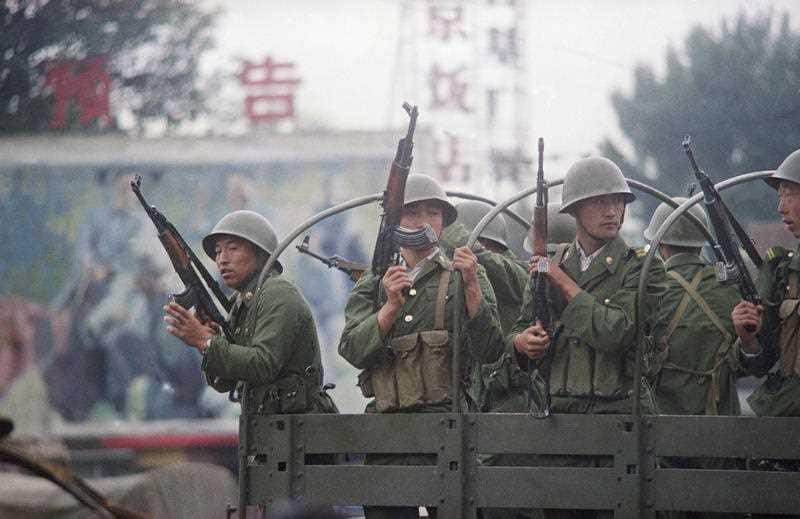 Chinese troops keep a sharp eye out during the pro-democracy protests in 1989. AP was forced to smuggle their images passed the waiting soldiers.