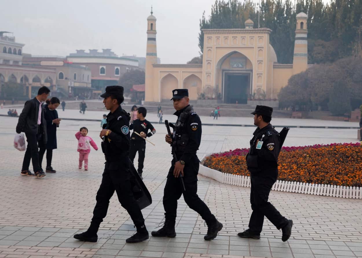 File photo, Uighur security personnel patrol near the Id Kah Mosque in Kashgar in western China's Xinjiang region