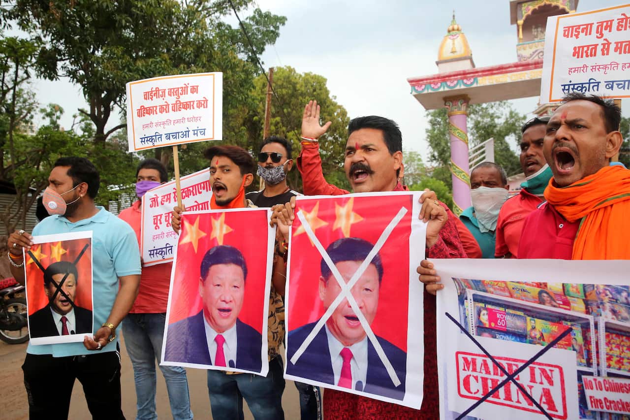 Protestors shout slogans as they stage a demonstration against China, holding posters of Chinese President Xi Jinping, in Bhopal, India.