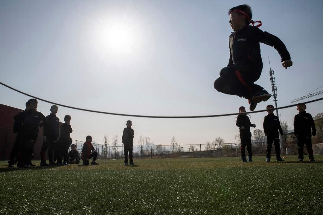 Boys enrolled at the Real Boys Club jump rope in Beijing.