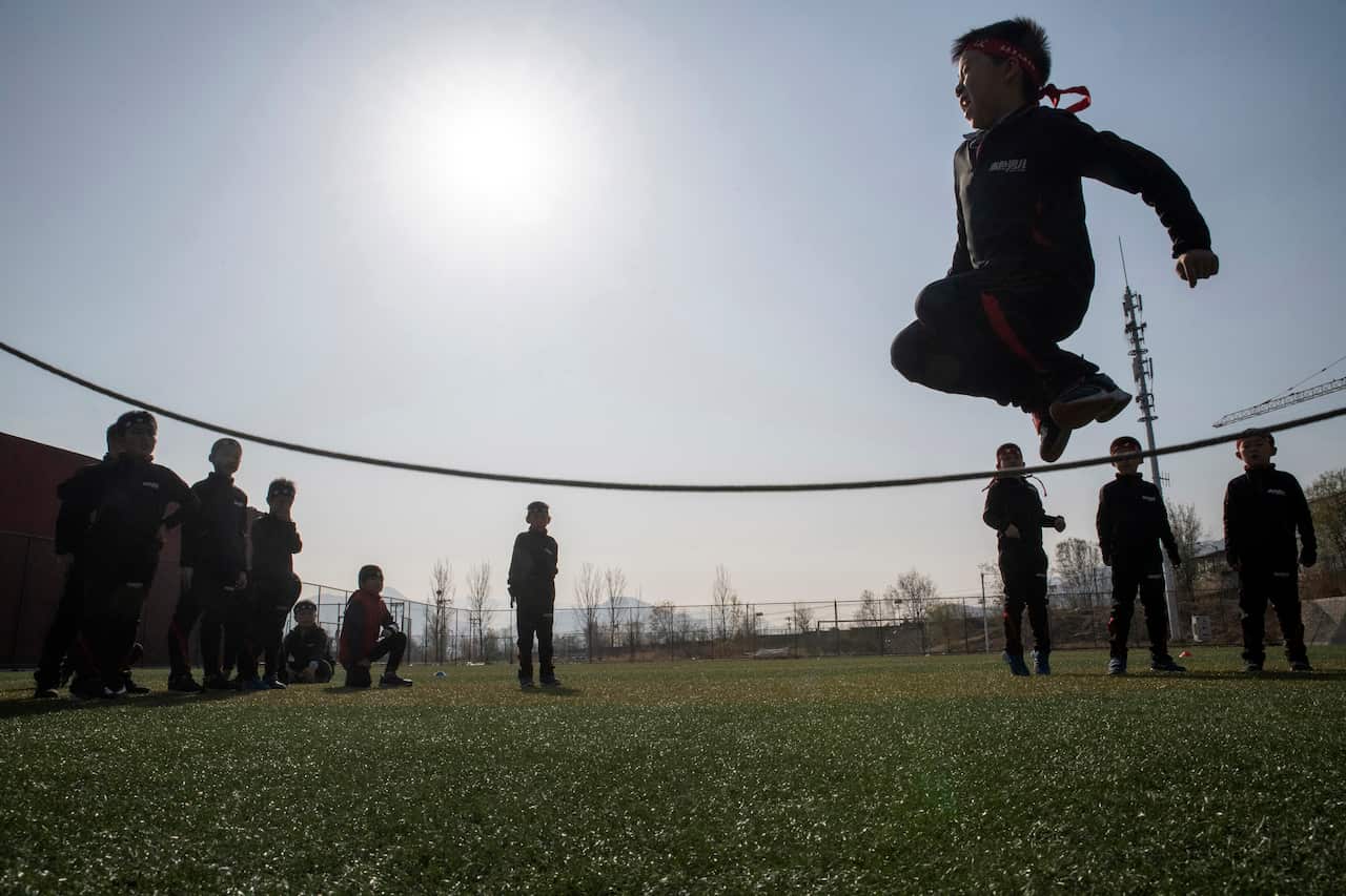 Boys enrolled at the Real Boys Club jump rope in Beijing.