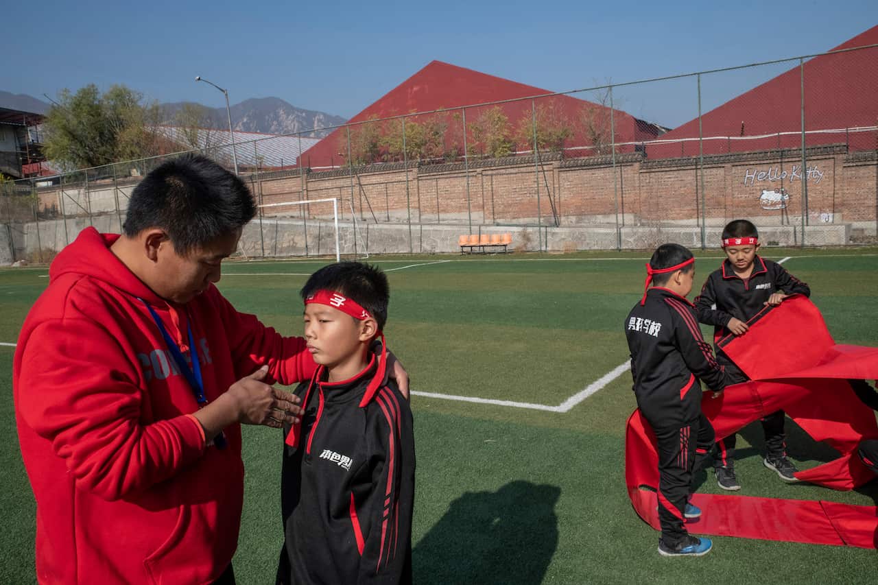 A teacher at the Real Boys Club lectures one of his students, in Beijing.