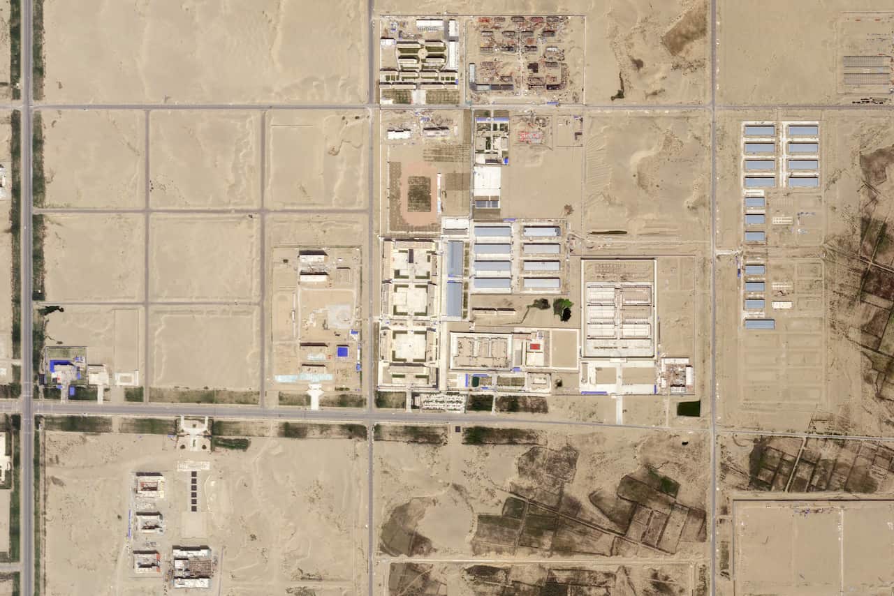 A satellite image taken over Hotan, China, in late August 2018, shows an internment camp, center, that has expanded.