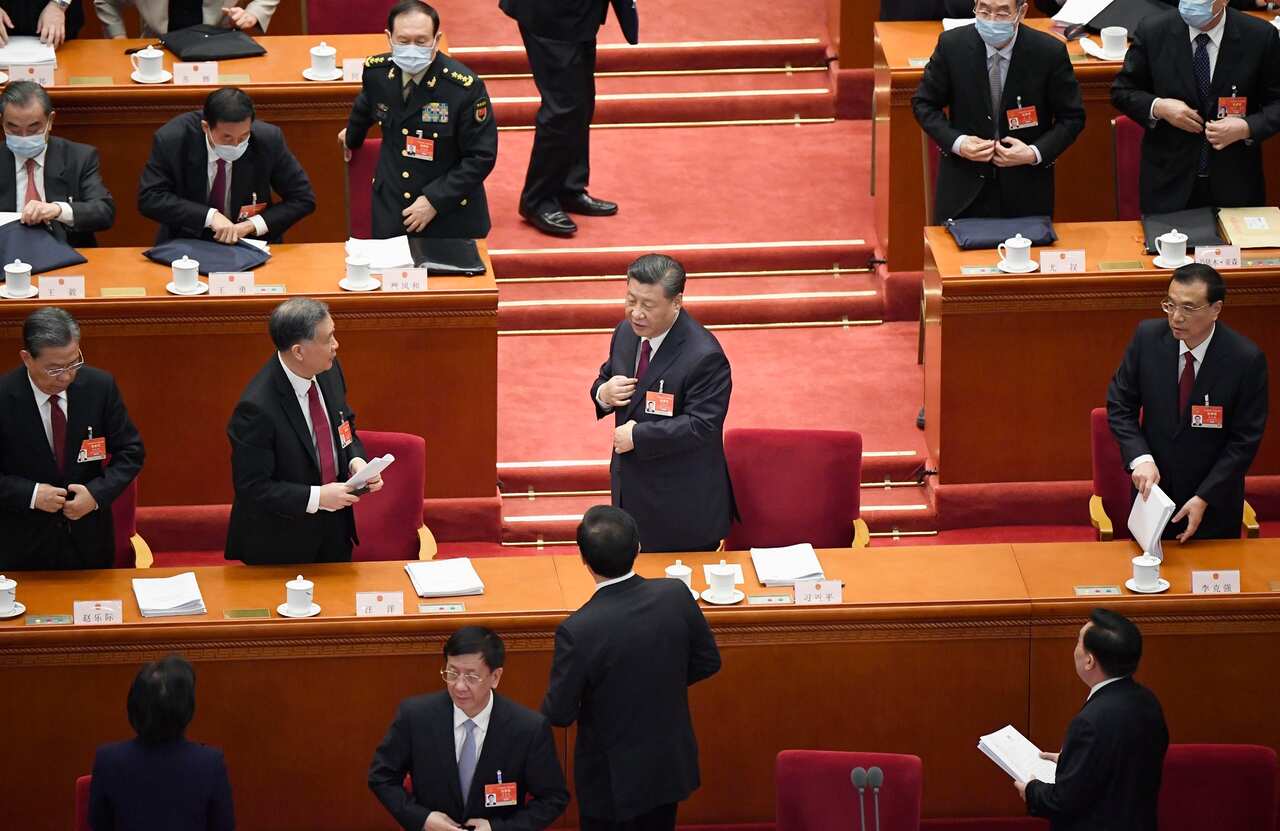 Chinese President Xi Jinping (centre) and Premier Li Keqiang (far right) at the opening ceremony of the National People's Congress.