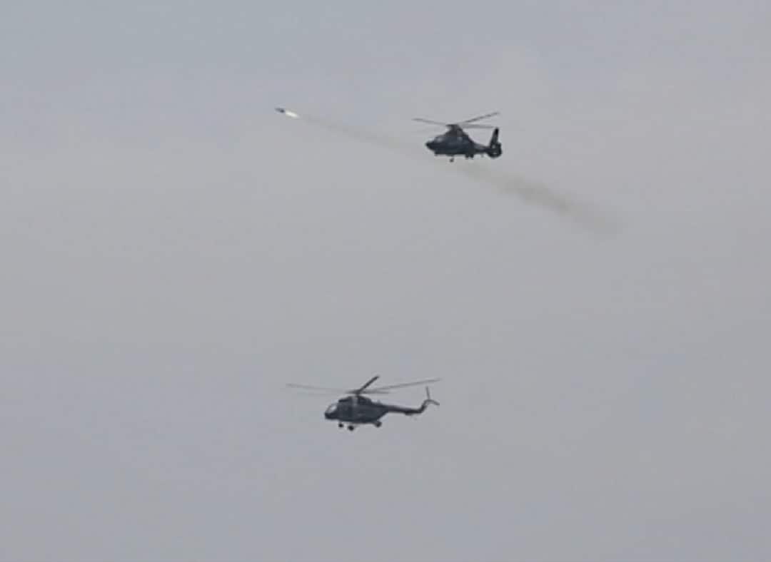 The helicopters fired missiles at distant objects in the water.