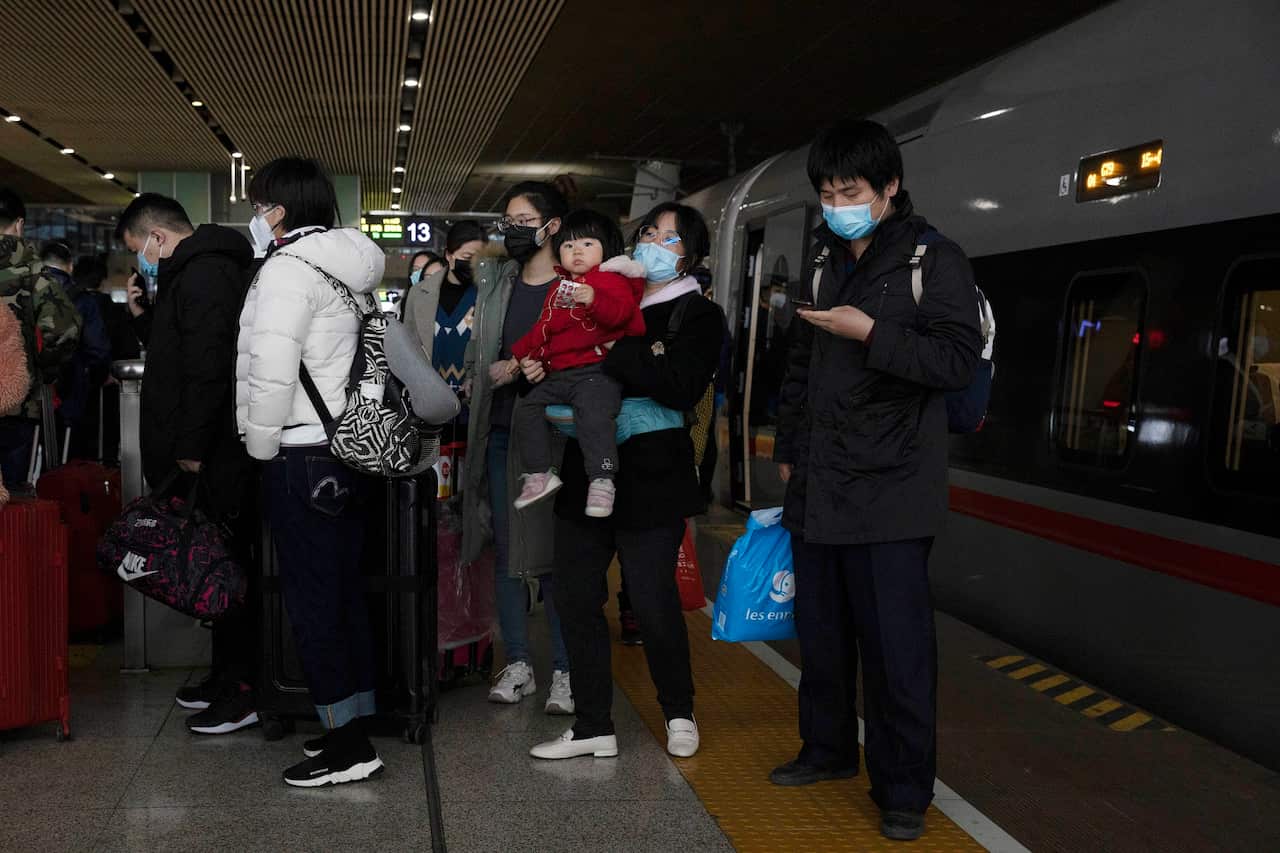 Passengers alight from a high speed train from beijing after it arrives in Wuhan.