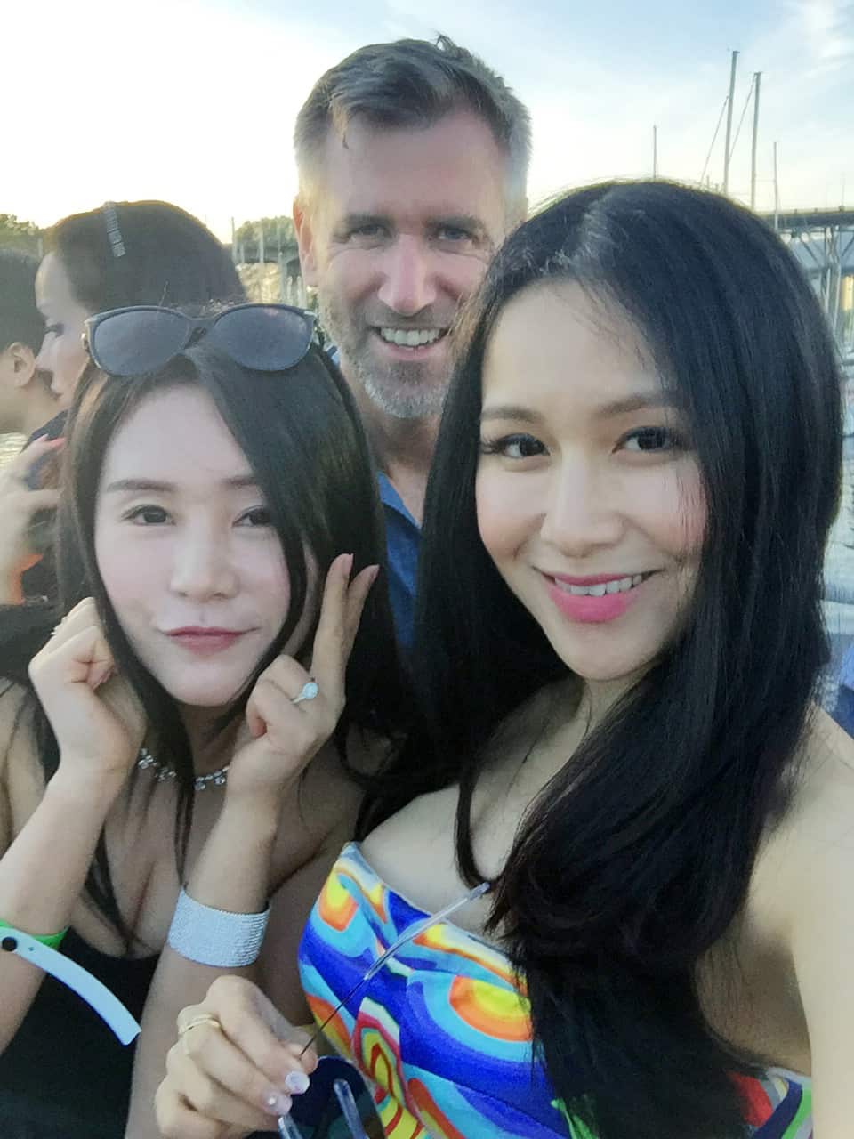 Dateline's Aaron Thomas with two 'Ultra Rich Asian Girls'.