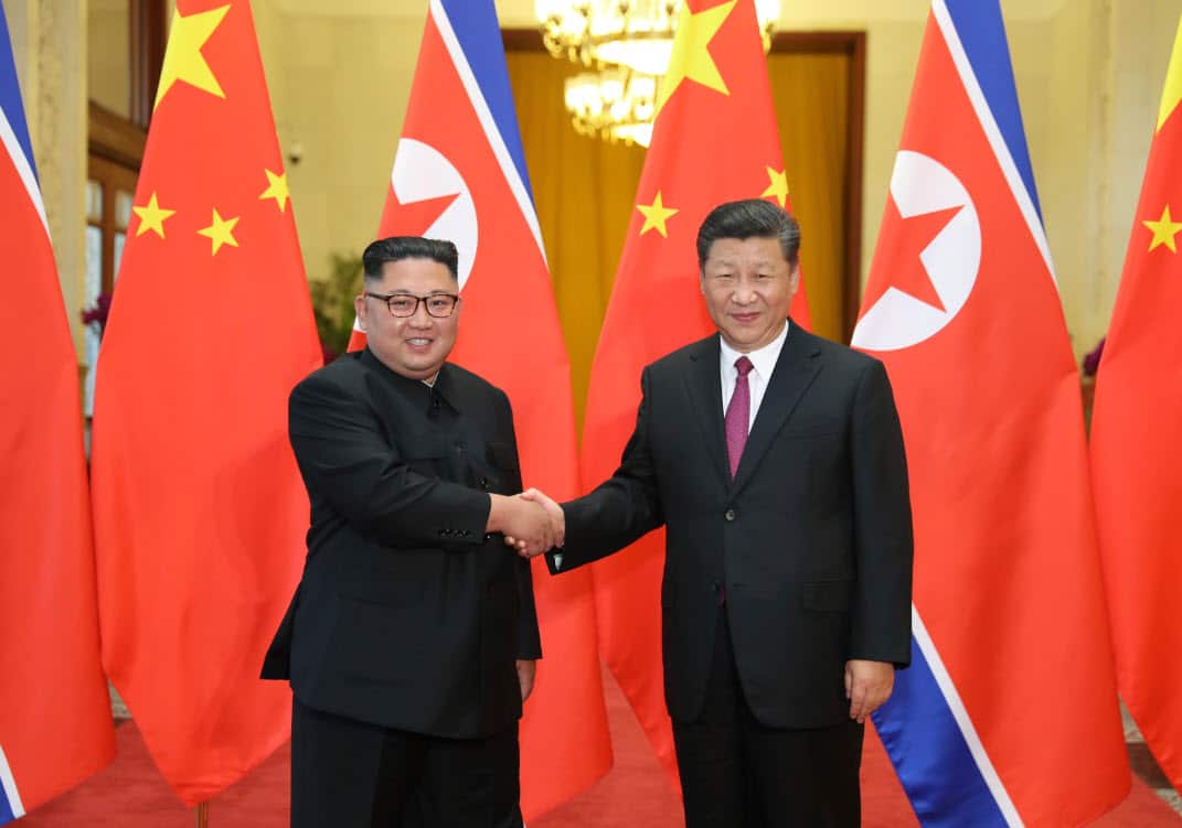 Chinese President Xi Jinping, right, shakes hands with North Korean leader Kim Jong Un, during a welcome ceremony at the Great Hall of the People in Beijing (AAP)