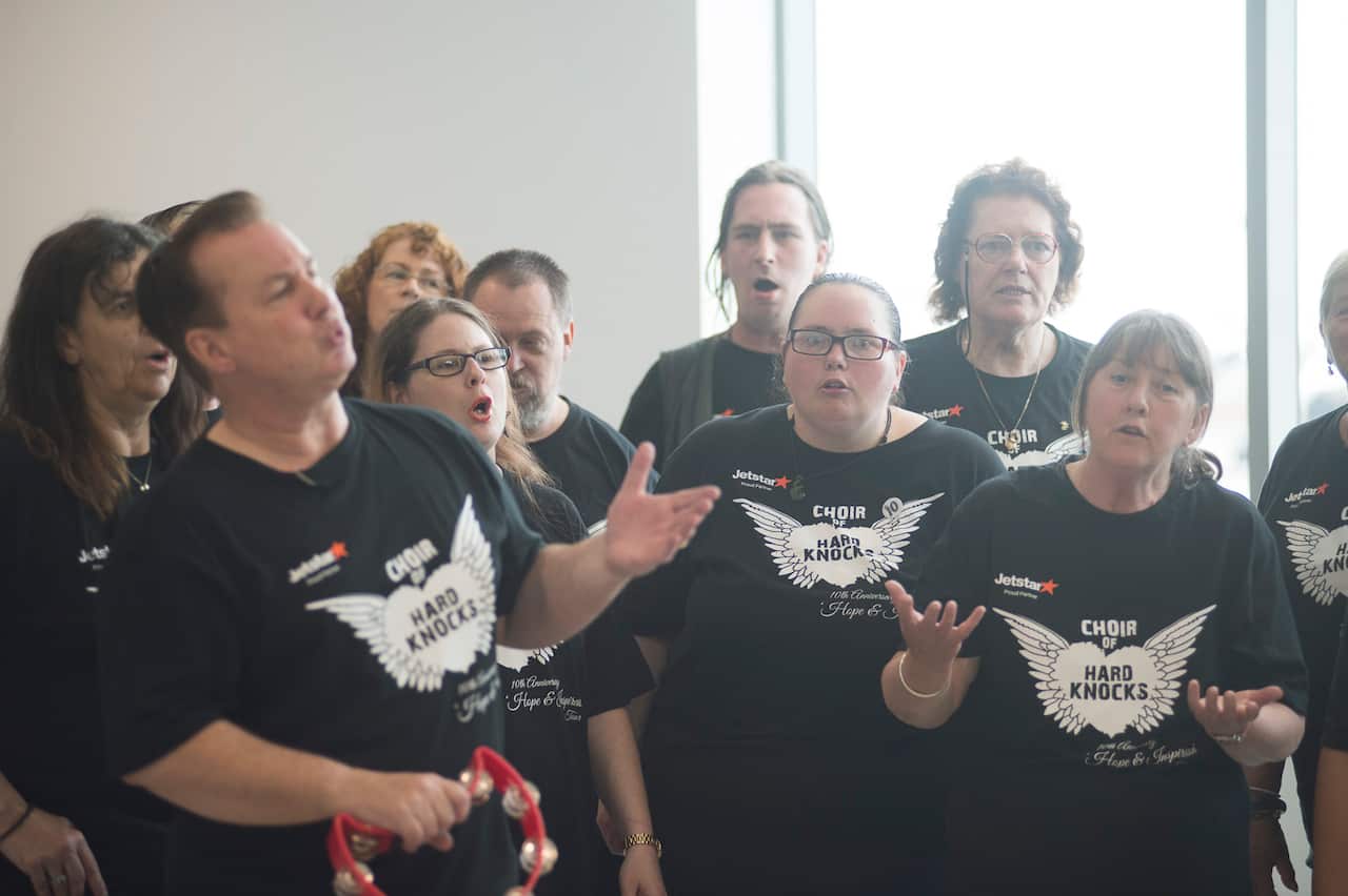 Choir members belting out songs at Melbourne Airport (SBS)