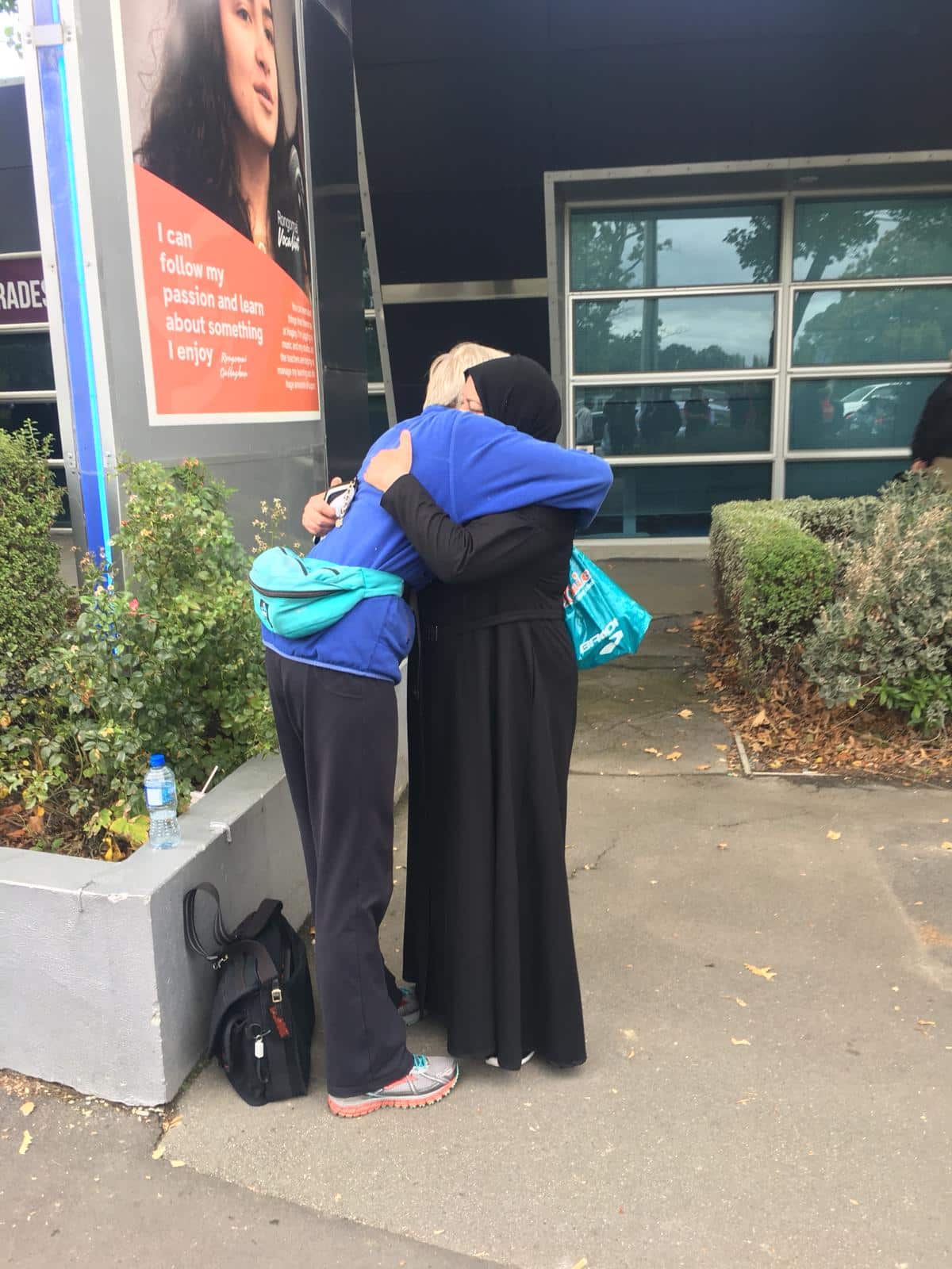 Mourners hug outside the Al Noor mosque on Saturday.