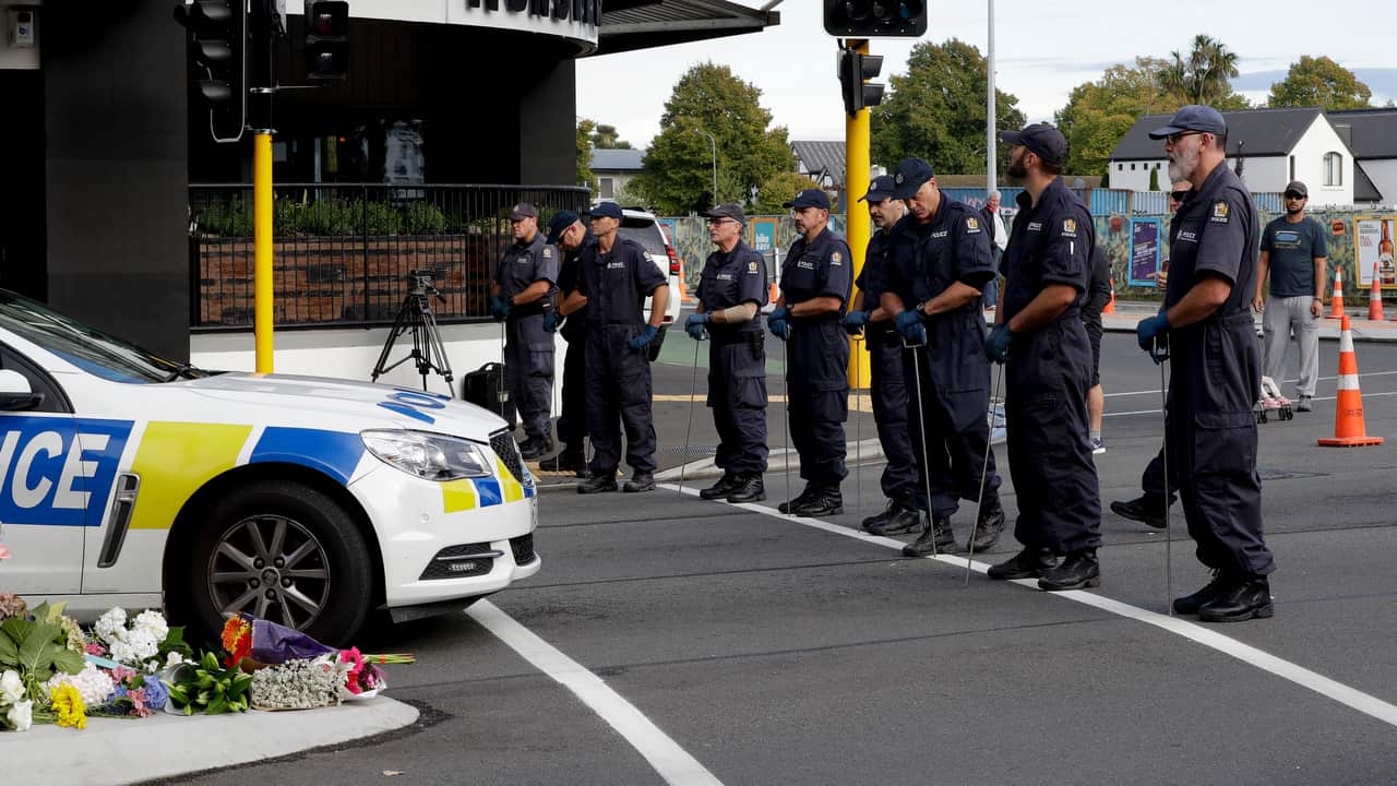 Police officers prepare to search the area near the Masjid Al Noor mosque, site of one of the mass shootings at two mosques in Christchurch.