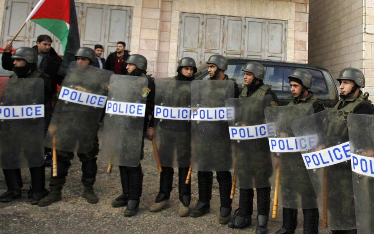 Palestinian policemen stand guard as the convoy of Jerusalem's Greek Orthodox patriarch Theophilos III arrives in the West Bank town of Bethlehem.