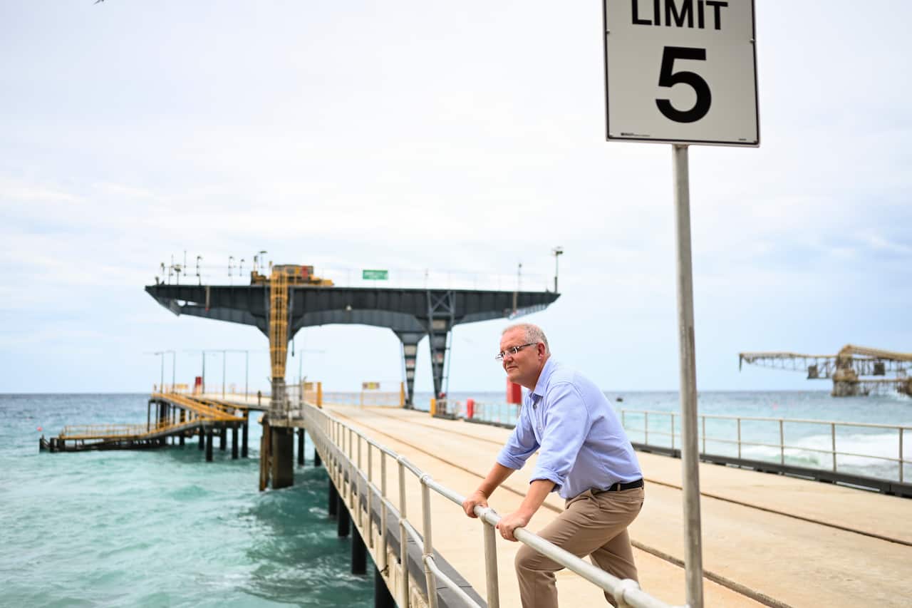 Australian Prime Minister Scott Morrison poses for photographs on the Christmas Island jetty.